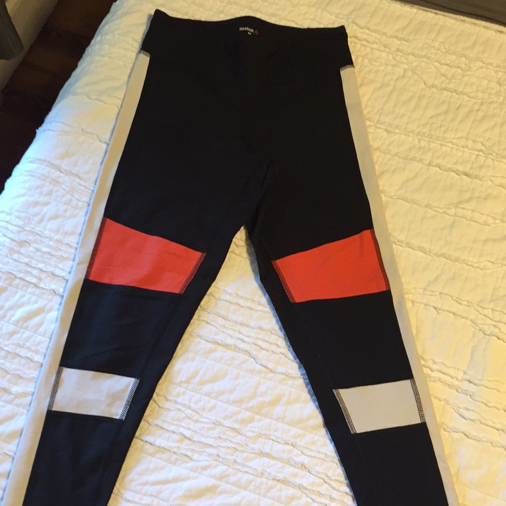 Black/orange/white Reebok leggings. Size Medium.